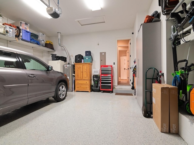 garage with water heater and a garage door opener