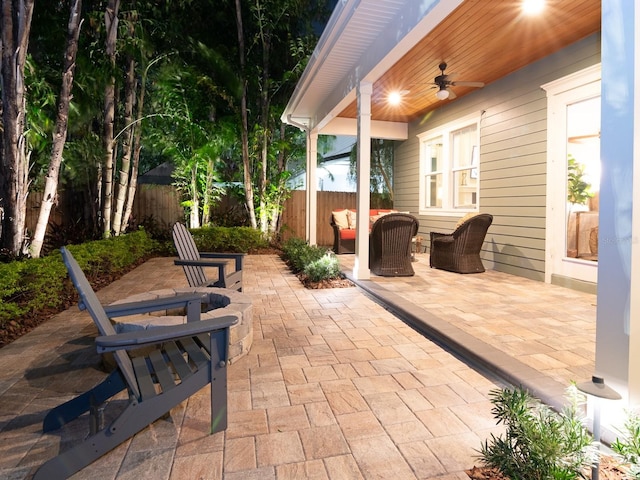 view of patio featuring fence and a ceiling fan