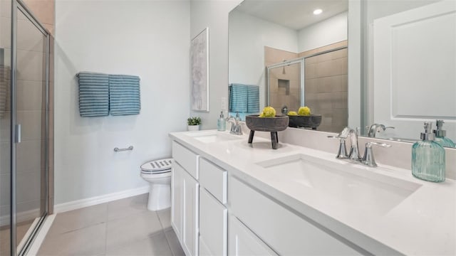 bathroom with a shower with shower door, vanity, toilet, and tile patterned floors