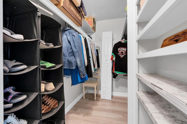 walk in closet featuring light wood-type flooring