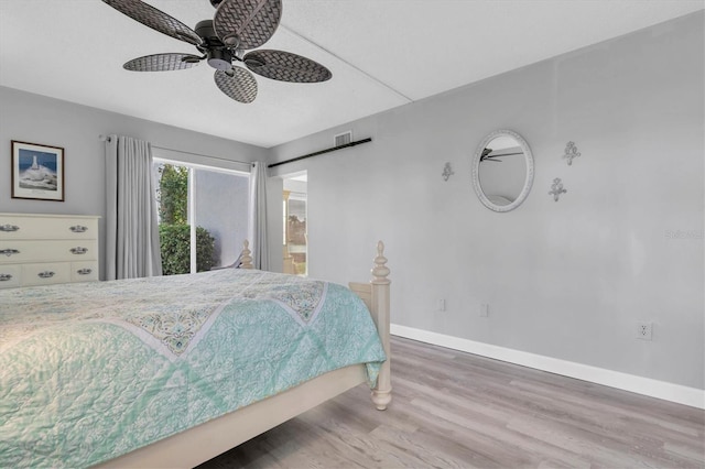 bedroom featuring hardwood / wood-style floors and ceiling fan