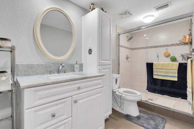 bathroom featuring toilet, an enclosed shower, vanity, and tile patterned floors