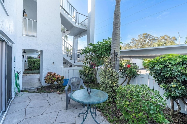 view of patio featuring a balcony