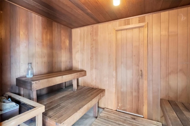 view of sauna / steam room featuring wood ceiling, wooden walls, and hardwood / wood-style flooring