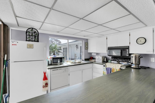 kitchen featuring white cabinets, a paneled ceiling, sink, and white appliances