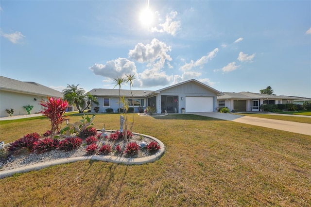 ranch-style home featuring a front lawn and a garage