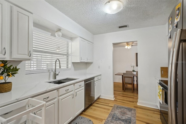 kitchen with dishwasher, light wood-type flooring, white cabinetry, and sink