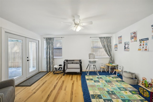 sitting room featuring hardwood / wood-style flooring, a healthy amount of sunlight, and french doors