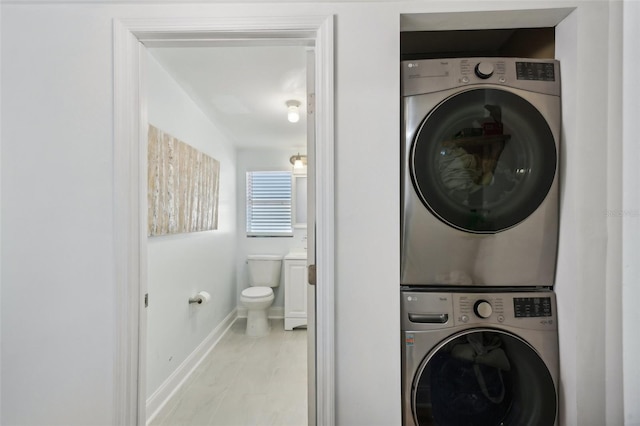 washroom with stacked washer / dryer