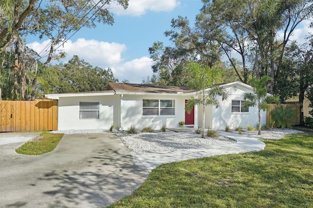 ranch-style home with a front lawn