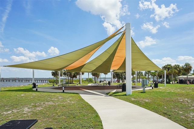 view of community with a water view, a lawn, and a gazebo