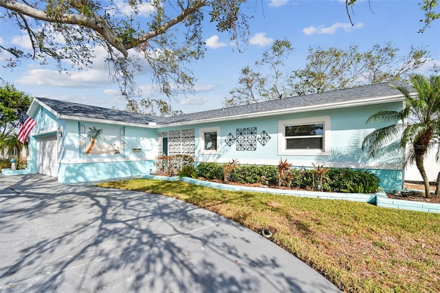 ranch-style house with a front lawn and a garage