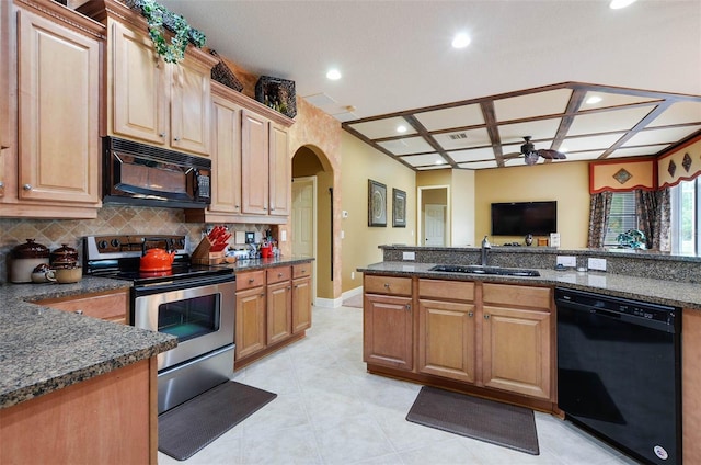 kitchen featuring black appliances, sink, coffered ceiling, ceiling fan, and dark stone countertops