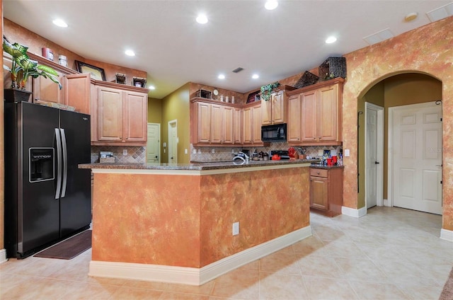 kitchen with black appliances, decorative backsplash, light tile patterned flooring, and a kitchen island with sink