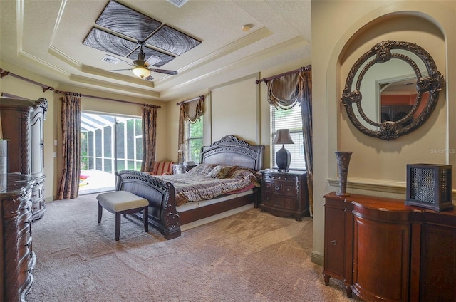 bedroom featuring access to outside, a tray ceiling, light colored carpet, and ceiling fan