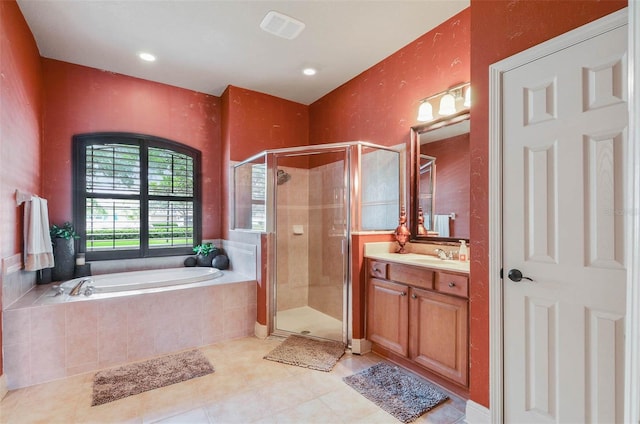 bathroom featuring vanity, tile patterned flooring, and separate shower and tub