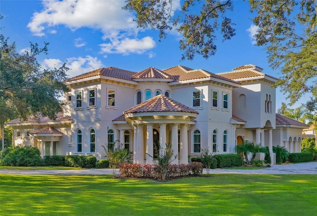 mediterranean / spanish house featuring a front yard