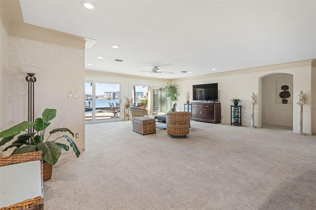 living room featuring light carpet and ceiling fan