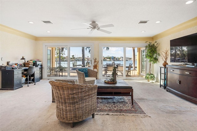 living area featuring recessed lighting, a ceiling fan, visible vents, and a textured ceiling