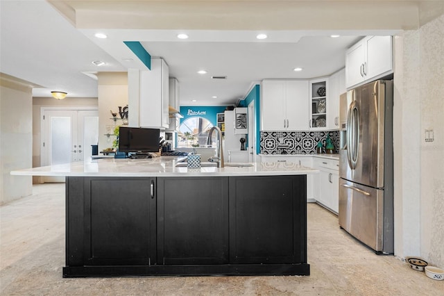 kitchen featuring stainless steel fridge with ice dispenser, light countertops, a peninsula, french doors, and white cabinetry