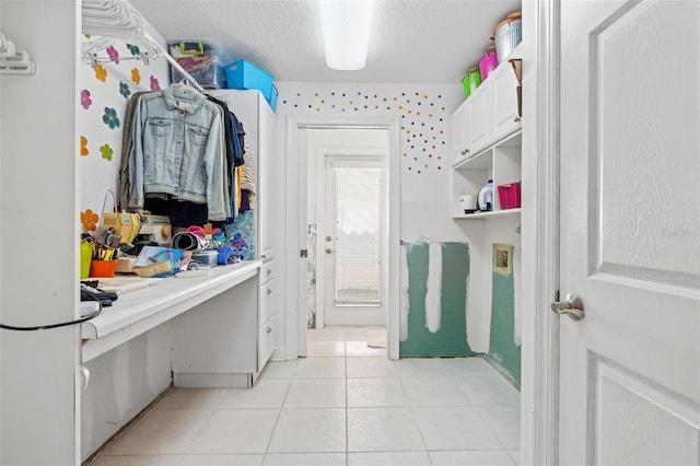 interior space featuring tile patterned flooring and a textured ceiling