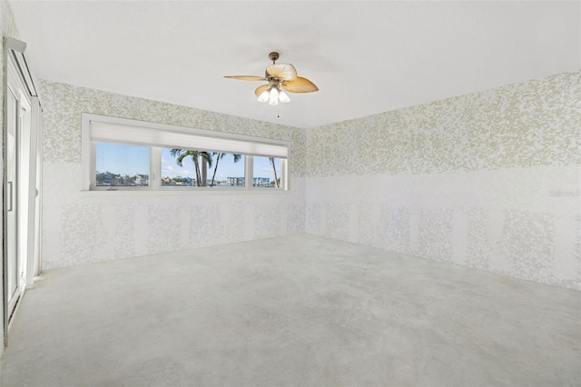 empty room featuring concrete flooring and ceiling fan