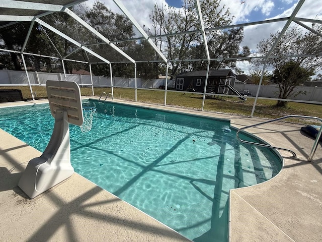 view of swimming pool with a fenced in pool, a fenced backyard, a lanai, a patio area, and a lawn