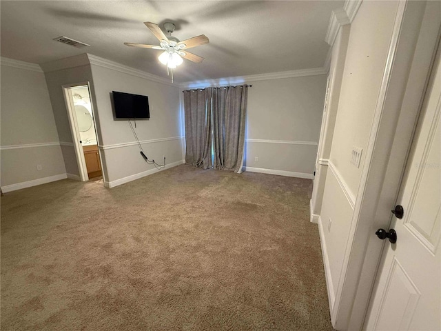 unfurnished bedroom featuring a ceiling fan, carpet, visible vents, baseboards, and crown molding