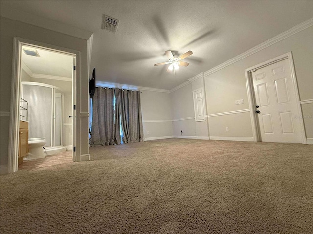 interior space featuring visible vents, ornamental molding, ensuite bathroom, carpet floors, and arched walkways