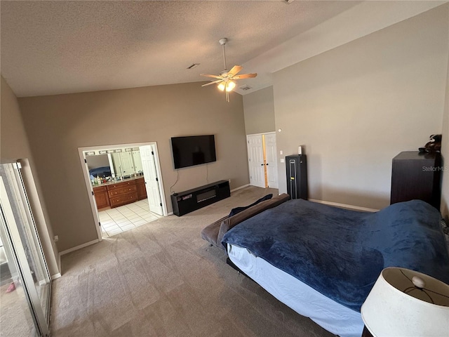 carpeted bedroom with high vaulted ceiling, a textured ceiling, ensuite bathroom, and a ceiling fan