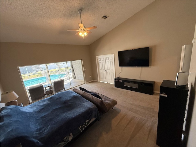 bedroom featuring visible vents, a ceiling fan, access to outside, a textured ceiling, and light colored carpet