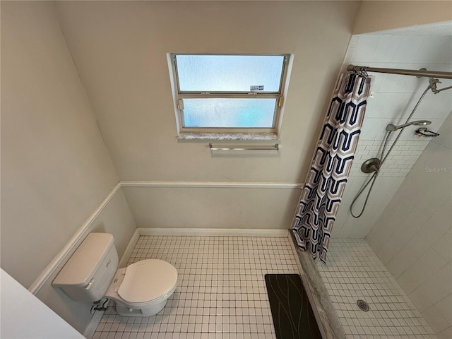 full bathroom with tile patterned floors, a shower stall, toilet, and baseboards