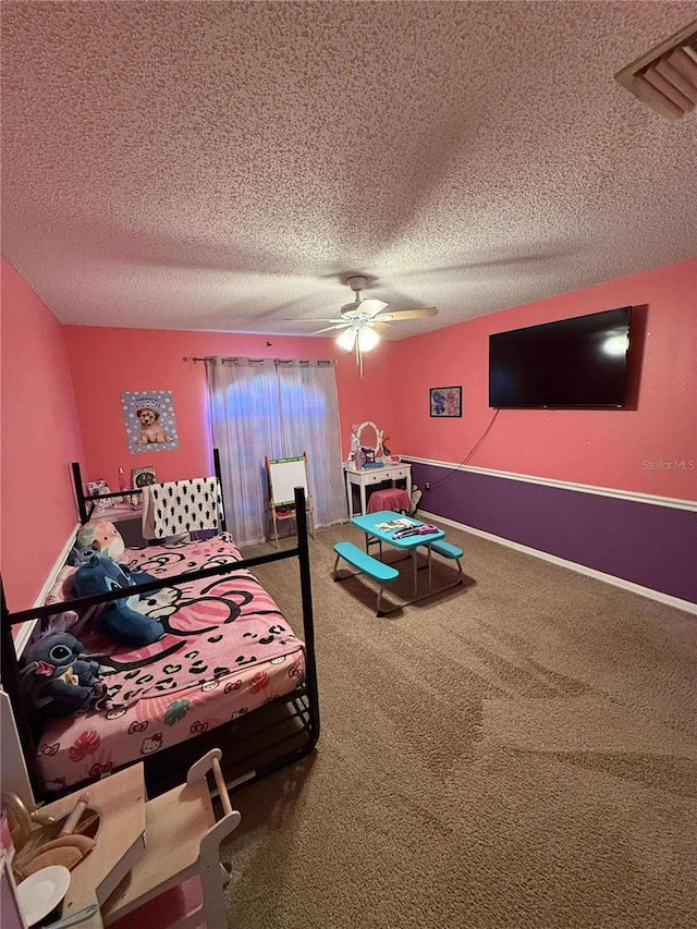 bedroom with visible vents, baseboards, carpet flooring, a textured ceiling, and a ceiling fan