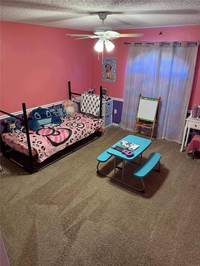 carpeted bedroom with a textured ceiling and ceiling fan