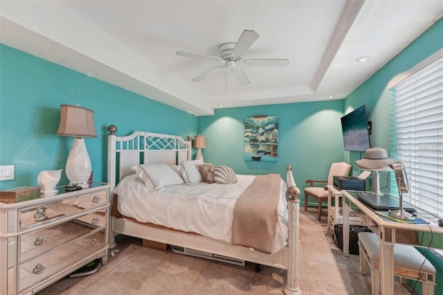 bedroom featuring a raised ceiling and ceiling fan