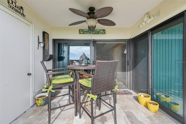 sunroom featuring ceiling fan