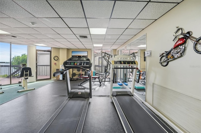 exercise room featuring a drop ceiling