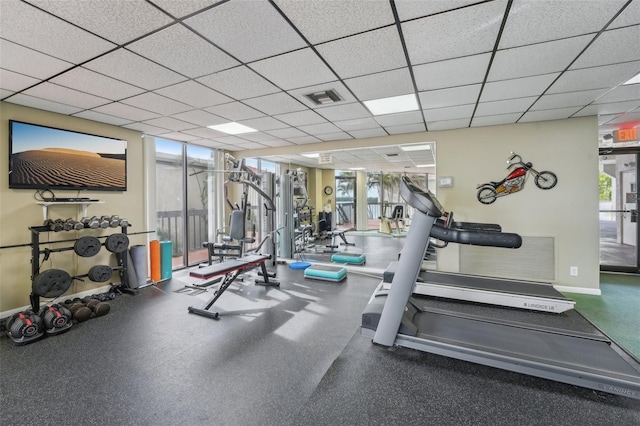 exercise room with a paneled ceiling