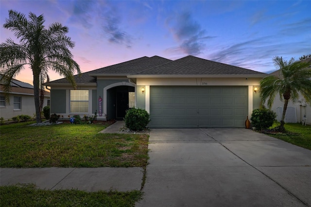 single story home with a yard and a garage