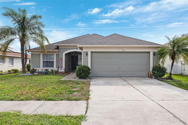 ranch-style house with a front yard and a garage