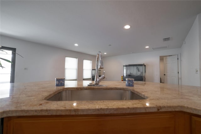 kitchen with sink and light stone counters