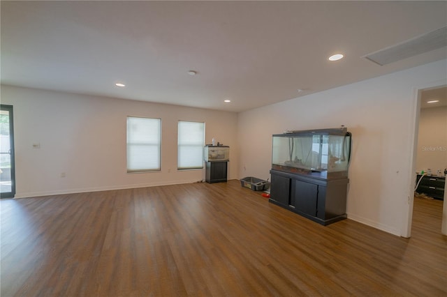 unfurnished living room featuring dark hardwood / wood-style floors