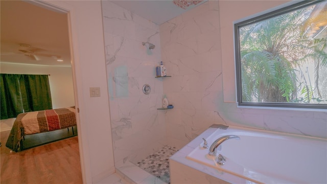 bathroom featuring separate shower and tub