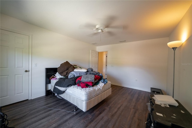 bedroom with ceiling fan and dark hardwood / wood-style flooring