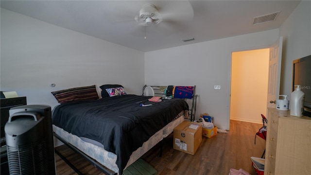 bedroom with ceiling fan and dark hardwood / wood-style floors