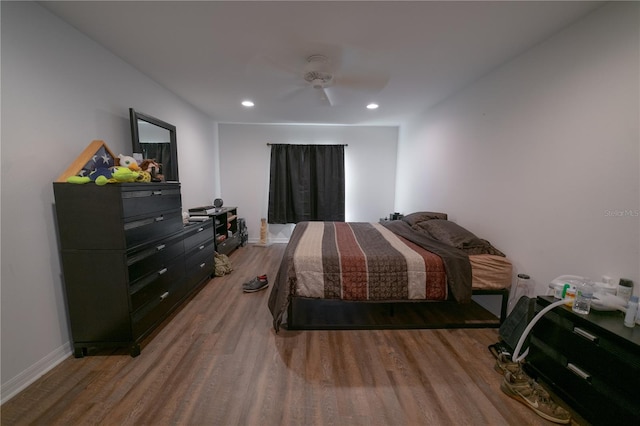 bedroom with hardwood / wood-style floors and ceiling fan