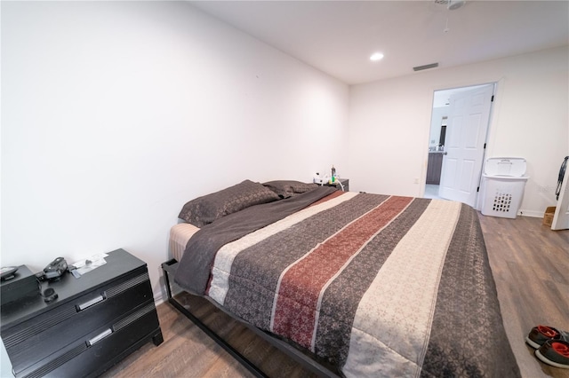 bedroom with hardwood / wood-style floors