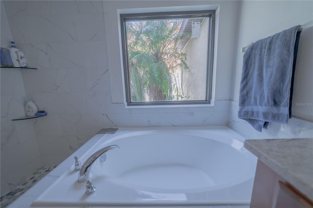 bathroom with vanity and a bath