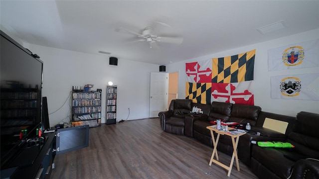 living room with dark wood-type flooring and ceiling fan