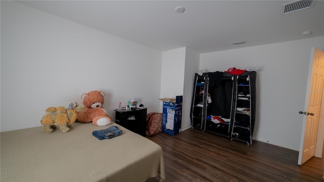 bedroom with dark hardwood / wood-style floors